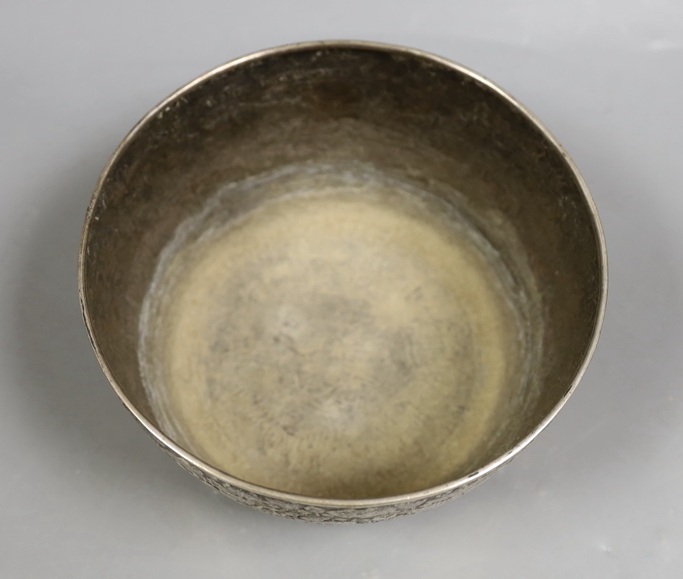 An Eastern embossed white metal bowl, diameter 17.7cm, 9.4oz.